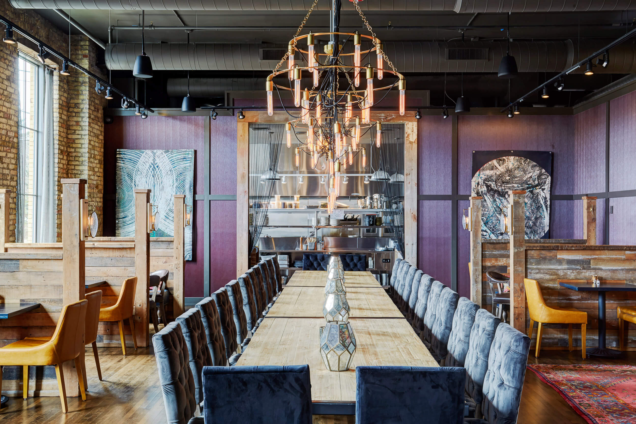 long-table-design-small-top-booth-design-brick-wallslpurple-accent-wall-restaurant-commercial-interior-design-services-milwaukee-wisconsin-peabodys-interiors